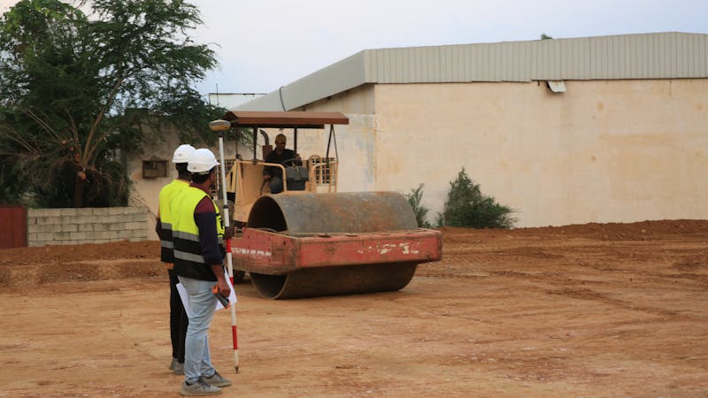 Surveyors monitoring soil compaction
