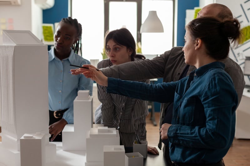 Team of professional architects brainstorming ideas.