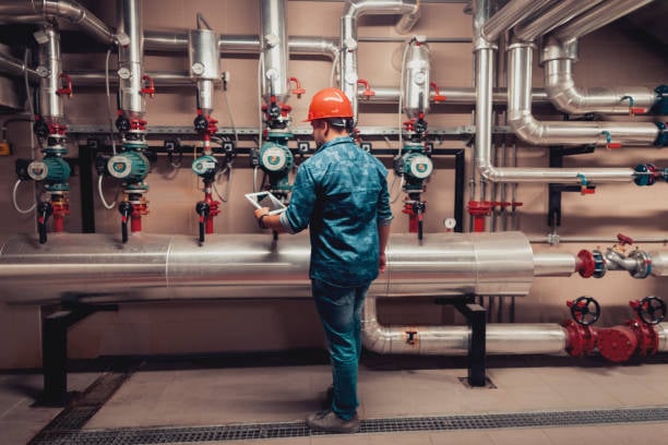 Technician inspecting building water and piping system