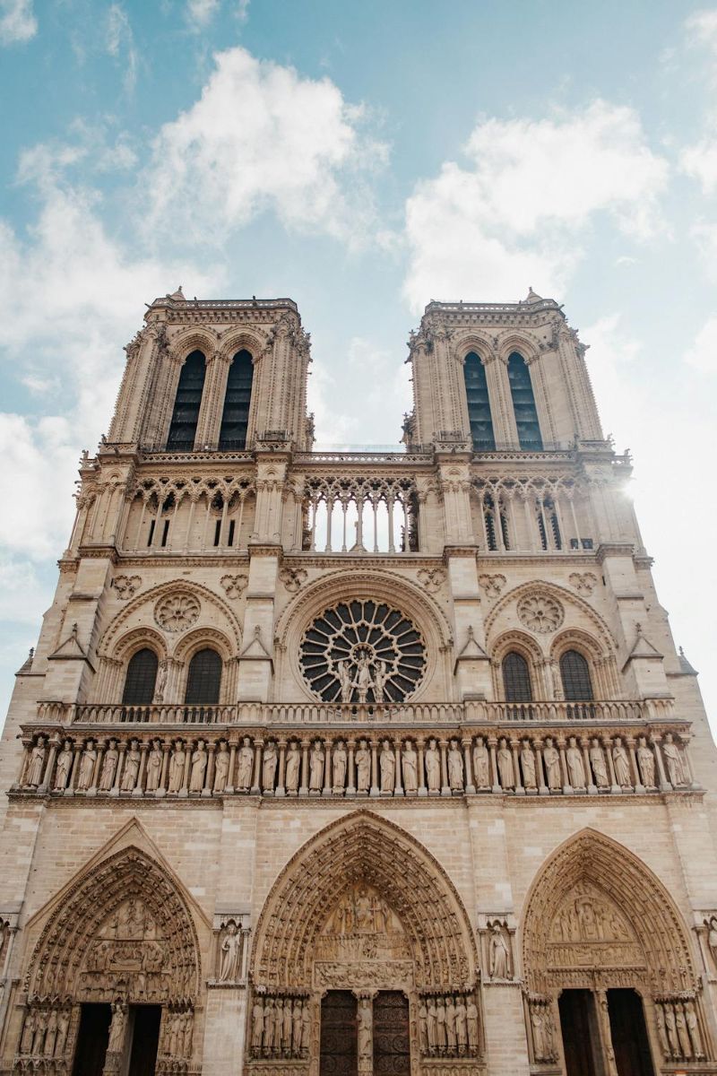 The photograph displays the cathedrals exterior, including twin towers and stained glass windows