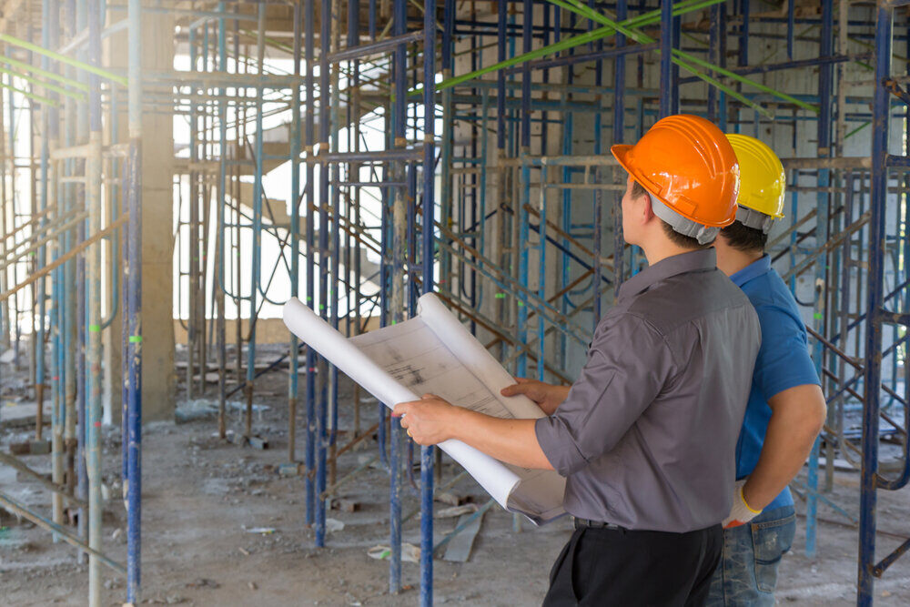 Two civil engineers reviewing the construction site