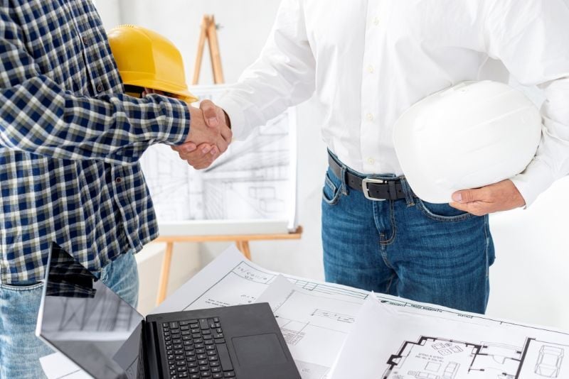 Two construction managers after a successful collaboration