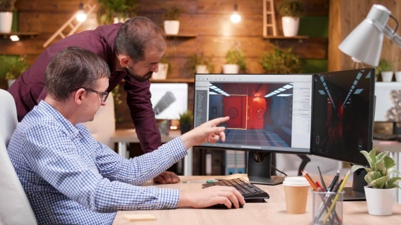 Two designers collaborating on a 3D rendering project.