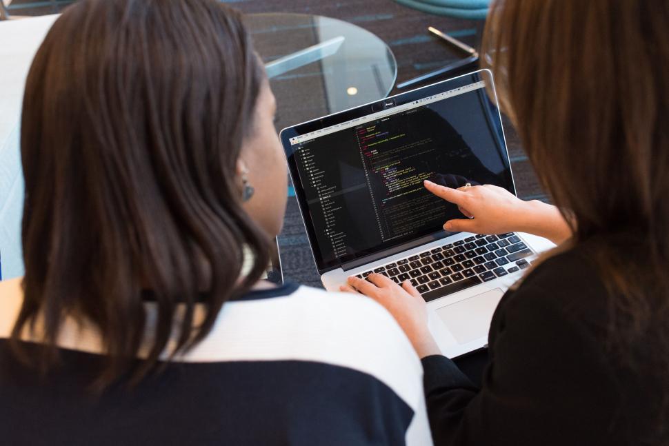 Two women collaborating on a coding project