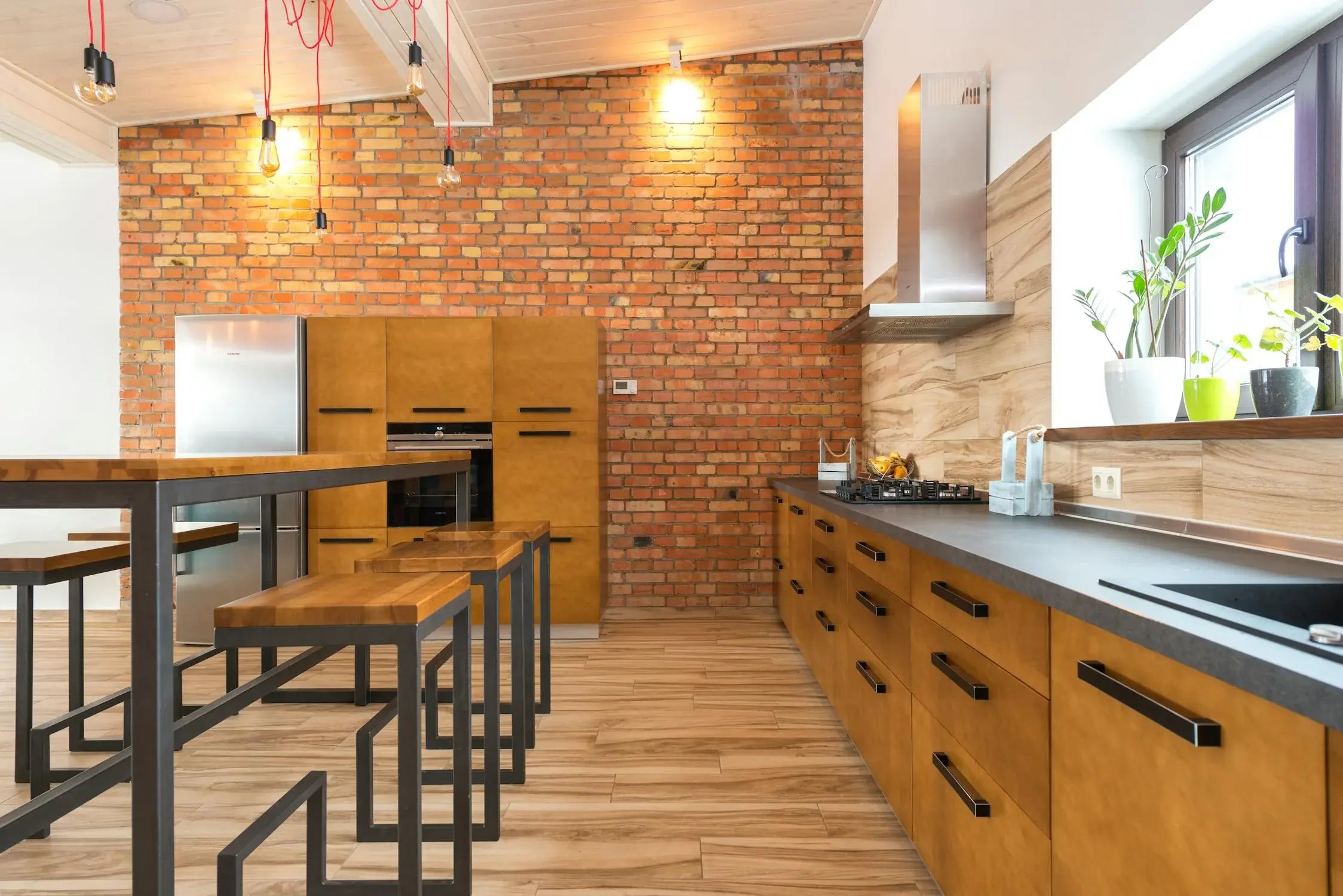 Wooden interior design of the kitchen area with one side brick wall 