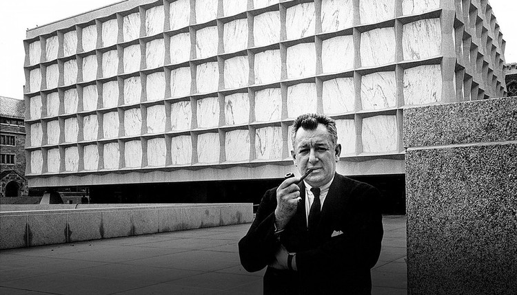 Gordon Bunshaft smoking a pipe by his design, the Beinecke Library at Yale