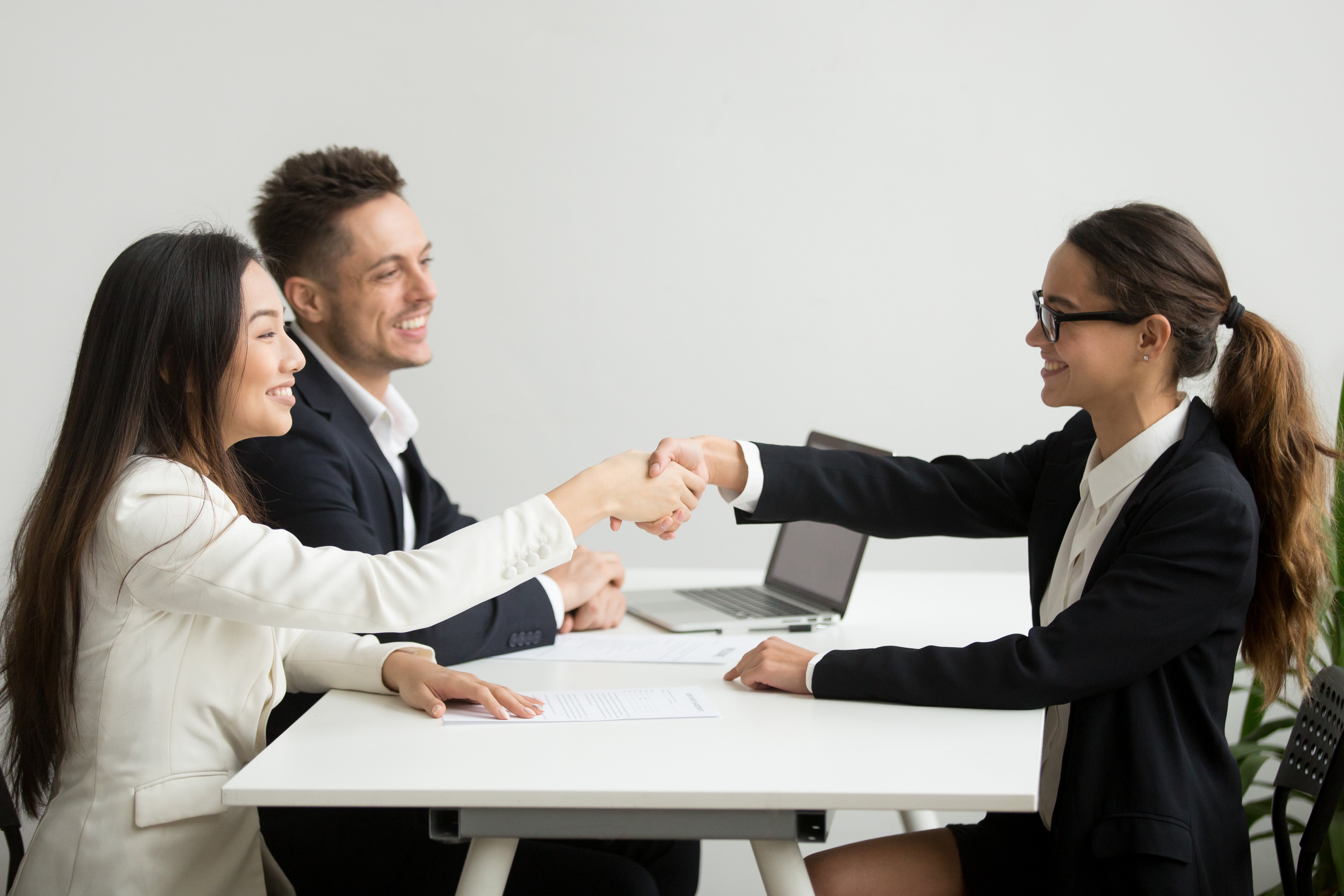 Employer and candidate shake hands in an interview